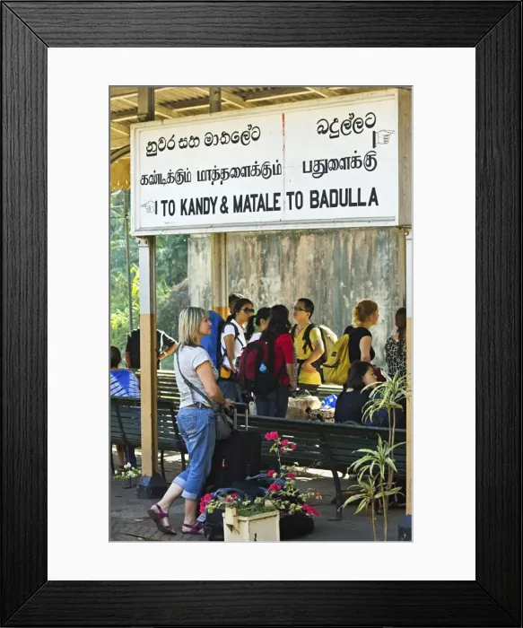 Framed Print : Foreign travellers await the popular Colombo to Badulla train at the railway station at Peradeniya Framed Print : Foreign travellers await the popular Colombo to Badulla train at the railway station at Peradeniya