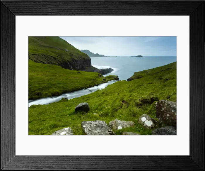 Framed Print : A stream running through the picturesque village of Gasadalur, which is overlooked by the 612m Heinanova mountain, Gasadalur, Vagar Island, Faroe Islands Framed Print : A stream running through the picturesque village of Gasadalur, which is overlooked by the 612m Heinanova mountain, Gasadalur, Vagar Island, Faroe Islands