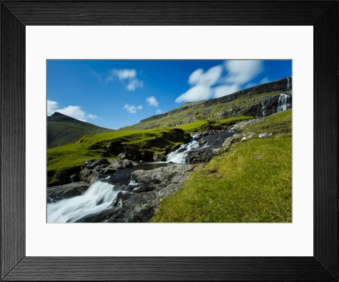 Framed Print : A waterfall running into the seawater lagoon, located in the picturesque village of Saksun Framed Print : A waterfall running into the seawater lagoon, located in the picturesque village of Saksun