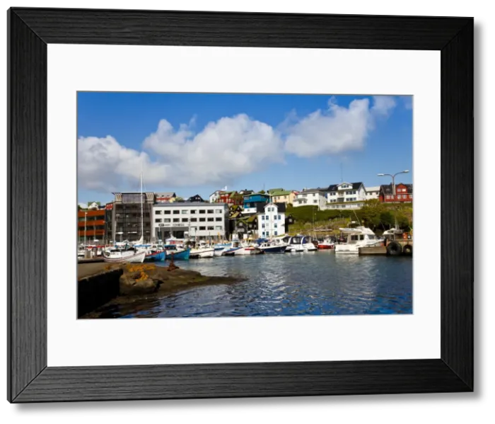 Framed Print : Boats moored in the harbour which is located next to the historical area known as Tinganes Framed Print : Boats moored in the harbour which is located next to the historical area known as Tinganes
