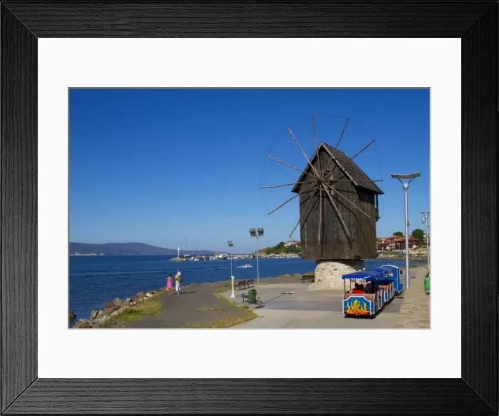 Framed Print : Historical wooden windmill on the Isthmus and small sightseeing tourist train Framed Print : Historical wooden windmill on the Isthmus and small sightseeing tourist train