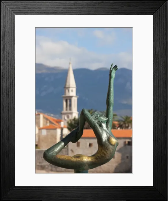 Framed Print : Statue of naked dancing girl on a rock with Budva old town in the background Framed Print : Statue of naked dancing girl on a rock with Budva old town in the background