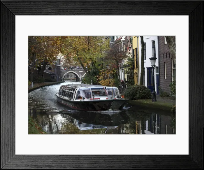 Framed Print : A sightseeing barge tours along the Oudegracht Canal in the Dutch city of Utrecht Framed Print : A sightseeing barge tours along the Oudegracht Canal in the Dutch city of Utrecht