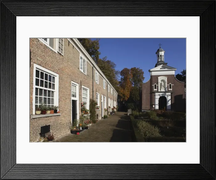 Framed Print : Chapel and brick housing within the courtyard of the Begijnhof (Beguinage) in Breda Framed Print : Chapel and brick housing within the courtyard of the Begijnhof (Beguinage) in Breda