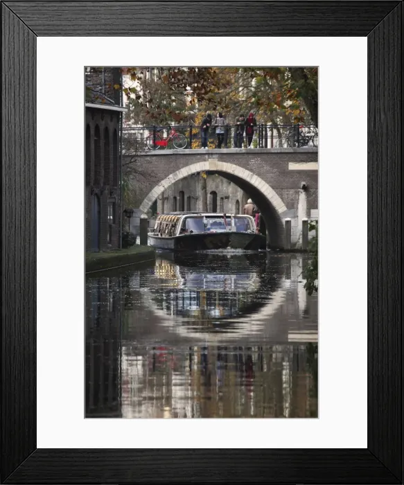 Framed Print : A sightseeing barge under a bridge on the Oudegracht Canal in the Dutch city of Utrecht Framed Print : A sightseeing barge under a bridge on the Oudegracht Canal in the Dutch city of Utrecht
