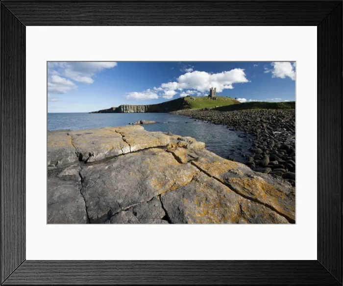 Framed Print : The ruins of Dunstanburgh Castle in the distance viewed from Greymare Rock on a sunny summers afternoon, Embleton Bay, Northumberland Framed Print : The ruins of Dunstanburgh Castle in the distance viewed from Greymare Rock on a sunny summers afternoon, Embleton Bay, Northumberland