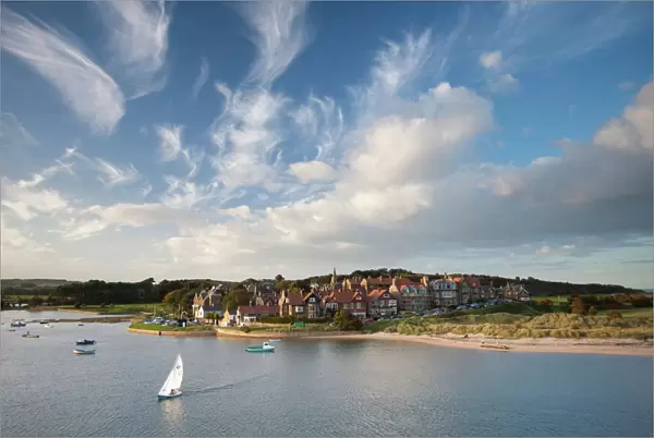 Alnmouth village and the Aln Estuary viewed from Church Hill on a calm late summers evening with a dramatic sky overhead, Alnmouth, near Alnwick, Northumberland, England, United