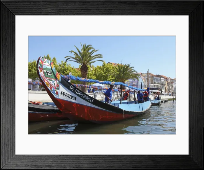Framed Print : The crew prepares a colourful Moliceiro boat for a sightseeing tour along the canals of Aveiro Framed Print : The crew prepares a colourful Moliceiro boat for a sightseeing tour along the canals of Aveiro