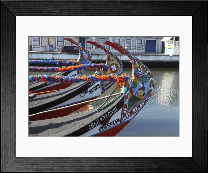 Framed Print : The prows of gondola-like Moliceiros, boats used to give tourists rides along the canals of Aveiro