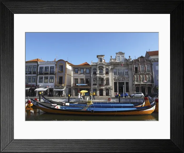 Framed Print : Moliceiro boats docked by Art Nouveau style buildings along the Central Canal Framed Print : Moliceiro boats docked by Art Nouveau style buildings along the Central Canal
