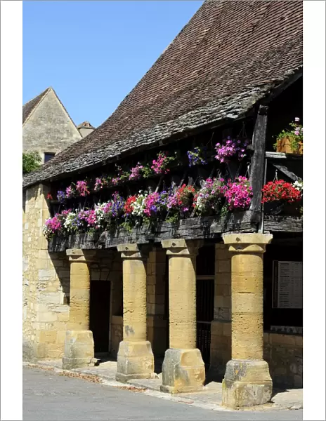 Flower bedecked medieval Les Halle, Bastide town of Domme, one of Les Plus Beaux Villages de France