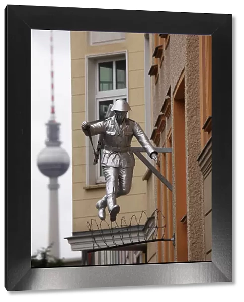 Berlin Television Tower (Fernsehturm) and sculpture of a soldier jumping the Berlin Wall at Bernauerstrasse, Berlin