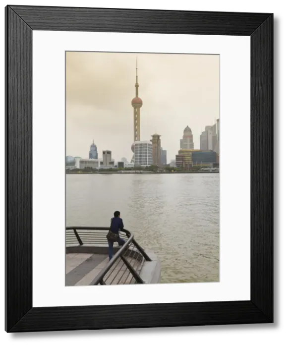 Framed Print : A man looking at the Oriental Pearl Tower and Pudong skyline across the Huangpu River from the Bund, Shanghai, China, Asia Framed Print : A man looking at the Oriental Pearl Tower and Pudong skyline across the Huangpu River from the Bund, Shanghai, China, Asia