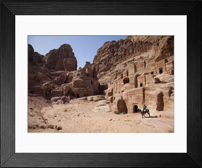 Framed Print : Child riding a donkey in front of cave dwellings in Petra, UNESCO World Heritage Site, Jordan, Middle East Framed Print : Child riding a donkey in front of cave dwellings in Petra, UNESCO World Heritage Site, Jordan, Middle East