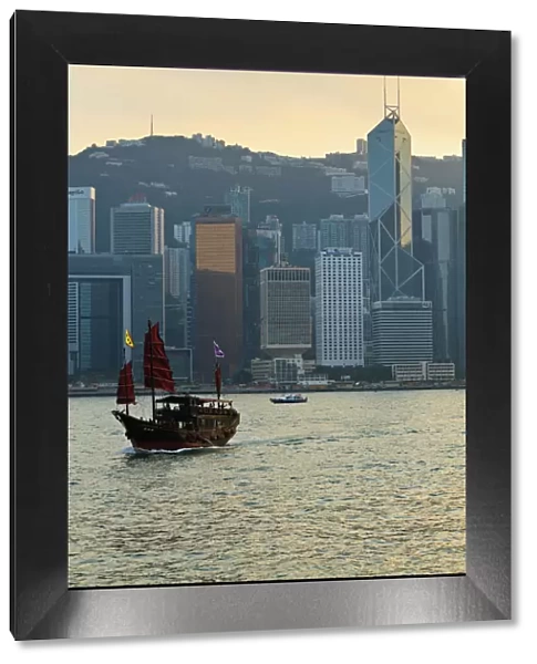 Chinese sailing junk on Victoria Harbour, the skyline of Central, Hong Kong Island beyond, Hong Kong, China, Asia