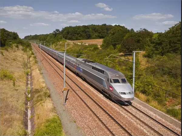 A TGV train speeds through the French countryside near to Tours, Indre-et-Loire, Centre, France, Europe