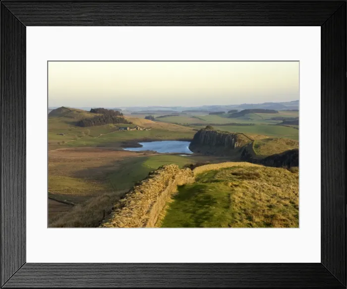 Framed Print : Towards sunset, view east along Hadrians Wall from Windshields Crag to Crag Lough and Hotbank Farm, UNESCO World Heritage Site, Northumberland National Park, Northumbria, England, United Kingdom, Europe