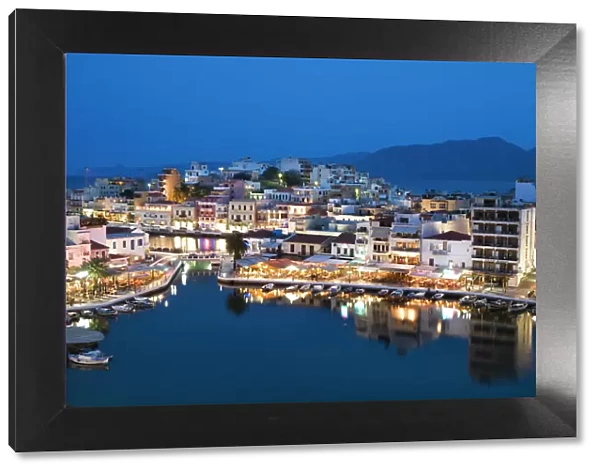 View over harbour and restaurants at dusk, Ayios Nikolaos, Lasithi region, Crete, Greek Islands, Greece, Europe