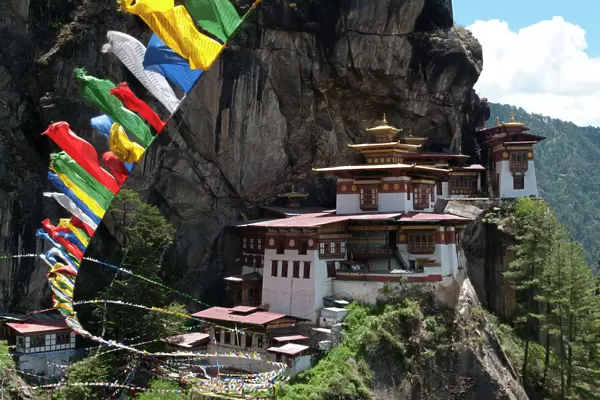 Taktshang Goemba (Tigers nest monastery) with prayer flags and cliff, Paro Valley, Bhutan, Asia