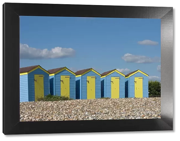 Five blue beach huts with yellow doors, Littlehampton, West Sussex, England, United Kingdom, Europe