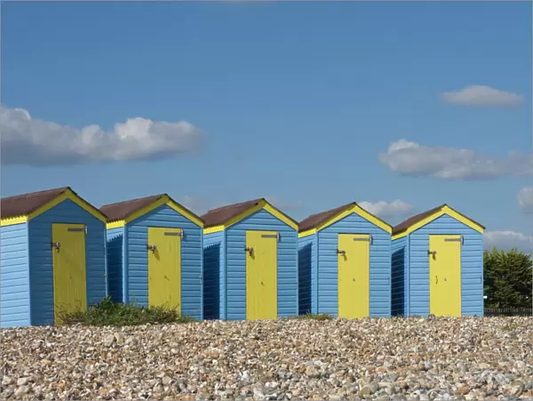 Five blue beach huts with yellow doors, Littlehampton, West Sussex, England, United Kingdom, Europe