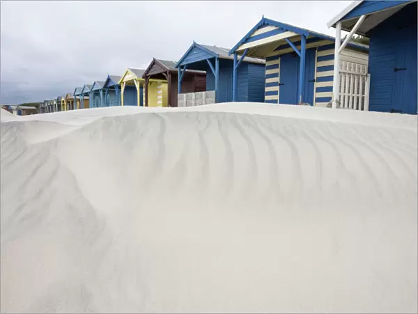 Beach huts in sand drift, West Wittering, West Sussex, England, United Kingdom, Europe