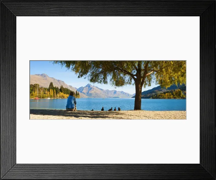 Framed Print : Panorama of a tourist relaxing by Lake Wakatipu in autumn at Queenstown, Otago, South Island, New Zealand, Pacific Framed Print : Panorama of a tourist relaxing by Lake Wakatipu in autumn at Queenstown, Otago, South Island, New Zealand, Pacific