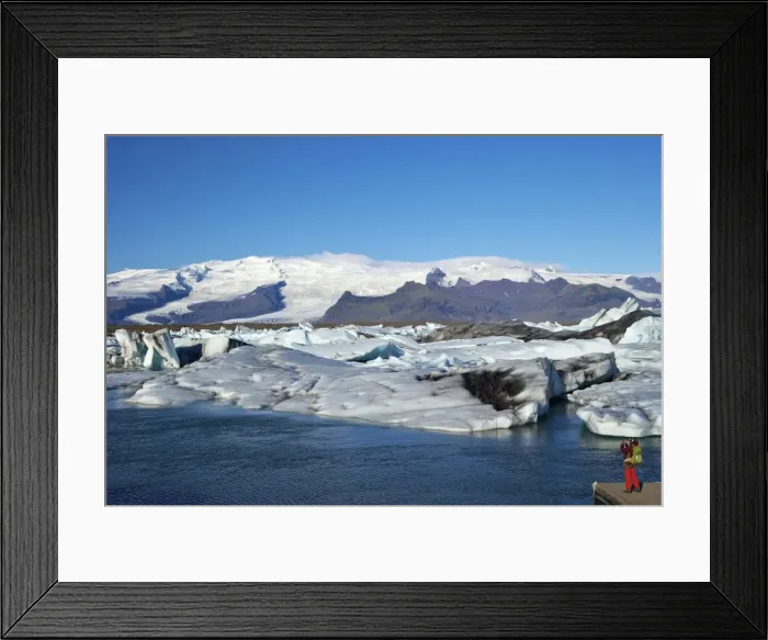 Framed Print : Man taking photo of icebergs on the glacial lake at Jokulsarlon with snow on the massive icecap of Vatnajokull behind, Iceland, Polar Regions Framed Print : Man taking photo of icebergs on the glacial lake at Jokulsarlon with snow on the massive icecap of Vatnajokull behind, Iceland, Polar Regions