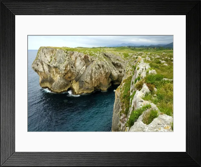 Framed Print : Karst limestone sea cliffs at Pria, with Picos de Europa mountains in the background, near Llanes, Asturias, Spain, Europe