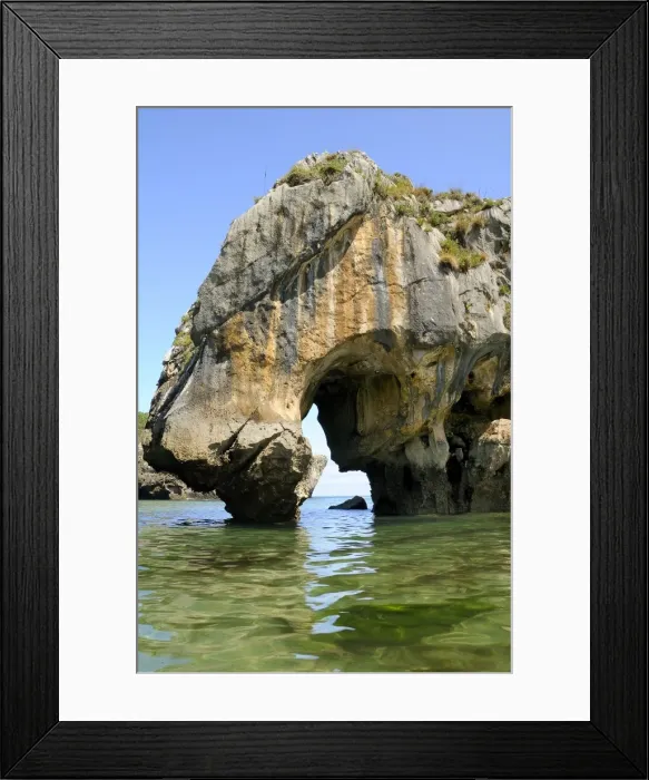 Framed Print : Natural rock archway carved by the sea through limestone rock at Cuevas del Mar (sea caves) beach, near Llanes, Asturias, Spain, Europe