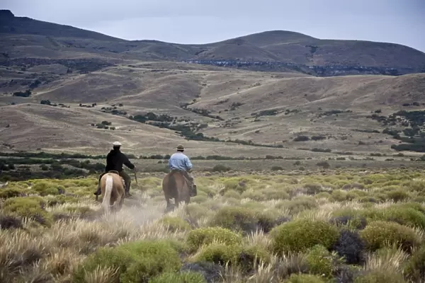 Gauchos riding horses, Patagonia, Argentina, South America