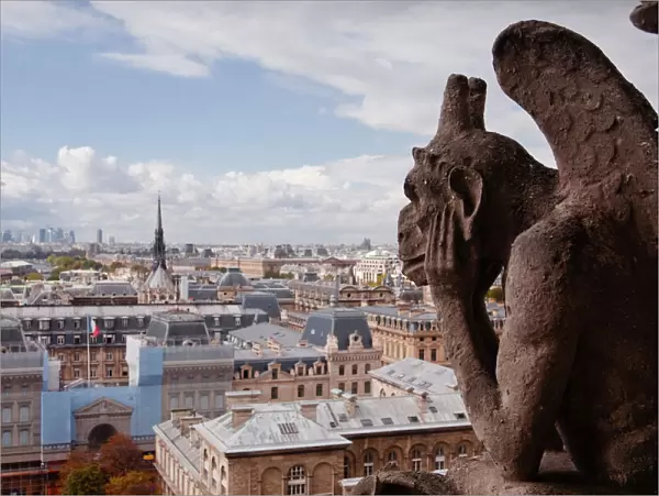 A gargoyle stares out from Notre Dame de Paris cathedral, Paris, France, Europe