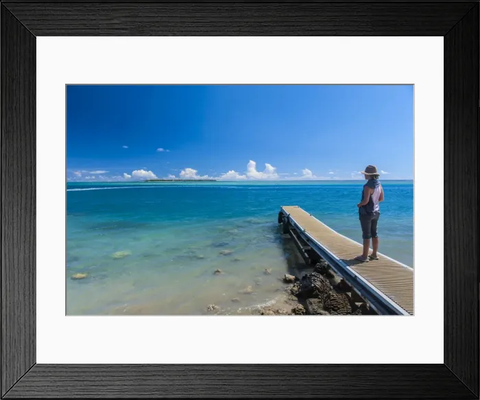 Framed Print : Tourist standing on a little pier with Cocos Island in the distance, Guam, US Territory, Central Pacific, Pacific Framed Print : Tourist standing on a little pier with Cocos Island in the distance, Guam, US Territory, Central Pacific, Pacific