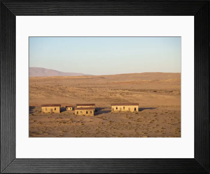 Framed Print : Buildings in the abandoned former German diamond mining town of Kolmanskop on the edge of the Namib Desert, Forbidden Diamond Area near Luderitz, Namibia