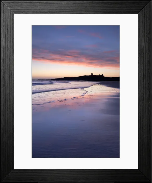 Framed Print : Looking across Embleton Bay at sunrise towards the silhouetted ruins of Dunstanburgh Castle in the distance and the vivid colours in the sky reflecting in the sea and wet sand, Embleton, near Alnwick, Northumberland, England, United Kingdom Framed Print : Looking across Embleton Bay at sunrise towards the silhouetted ruins of Dunstanburgh Castle in the distance and the vivid colours in the sky reflecting in the sea and wet sand, Embleton, near Alnwick, Northumberland, England, United Kingdom