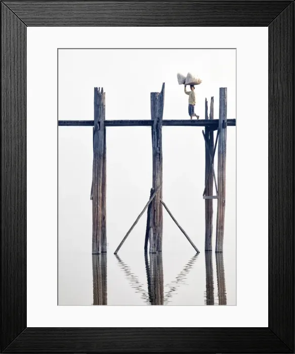 Framed Print : Local woman carrying goods on her head across U Bein Bridge, the worlds longest teak foot bridge spanning 1300 yards over Taungthaman Lake, Amarapura, near Mandalay, Myanmar (Burma), Asia
