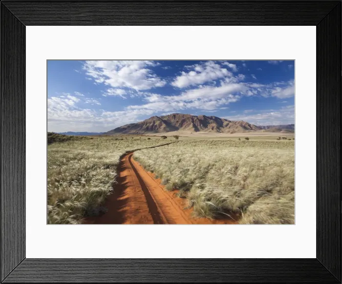 Framed Print : Sand road cutting across grassy landscape towards mountains, Wolwedans, Namib Rand Game Reserve, Namib Naukluft Park, Namibia, Africa Framed Print : Sand road cutting across grassy landscape towards mountains, Wolwedans, Namib Rand Game Reserve, Namib Naukluft Park, Namibia, Africa