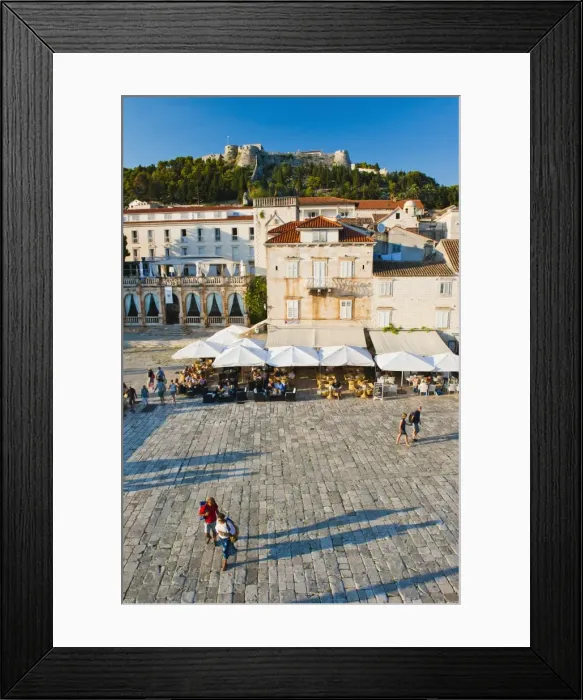 Framed Print : Tourists in St. Stephens Square, with the Spanish Fort (Fortica) above, Hvar Town, Hvar Island, Dalmatian Coast, Croatia, Europe Framed Print : Tourists in St. Stephens Square, with the Spanish Fort (Fortica) above, Hvar Town, Hvar Island, Dalmatian Coast, Croatia, Europe