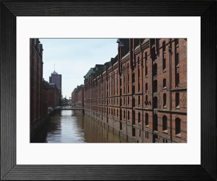 Framed Print : Red brick warehouses overlook a canal in the Speicherstadt district, once a duty free port, in Hamburg, Germany, Europe Framed Print : Red brick warehouses overlook a canal in the Speicherstadt district, once a duty free port, in Hamburg, Germany, Europe
