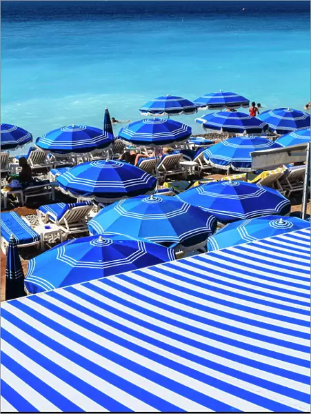 Beach parasols, Nice, Alpes Maritimes, Provence, Cote d Azur, French Riviera, France, Europe