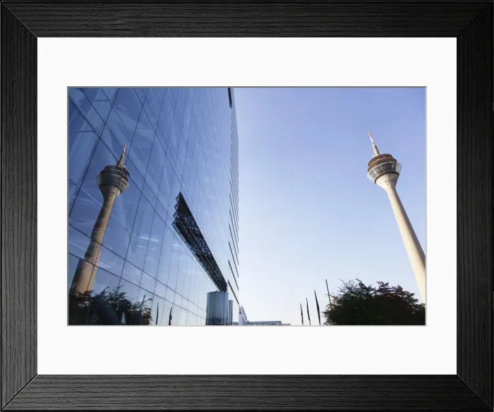Framed Print : Rheinturm tower reflecting in the facade of Stadttor building, Dusseldorf, North Rhine-Westphalia, Germany, Europe Framed Print : Rheinturm tower reflecting in the facade of Stadttor building, Dusseldorf, North Rhine-Westphalia, Germany, Europe