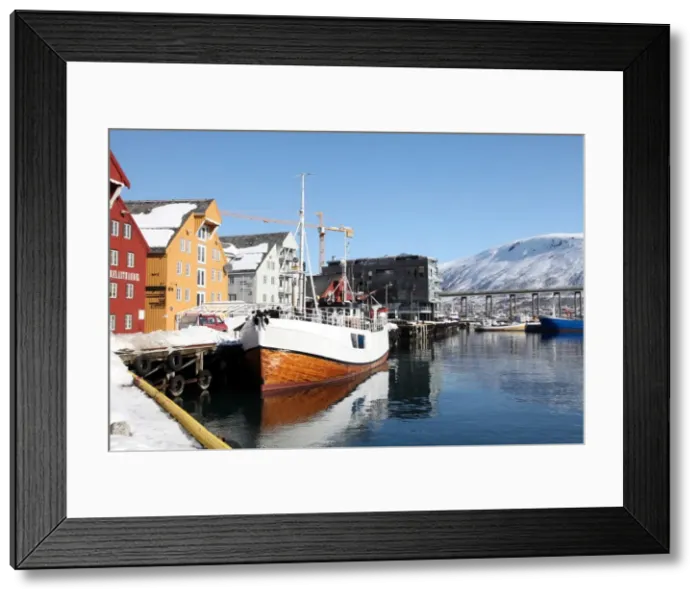 Framed Print : The whaler that used to go to Svalbard, with warehouses behind that have been converted into offices, Tromso, Troms, Norway, Scandinavia, Europe