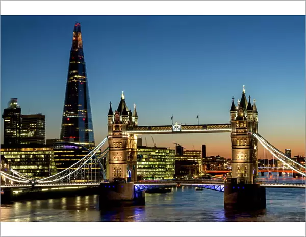View of the Shard and Tower Bridge standing tall above the River Thames at dusk, London, England, United Kingdom, Europe