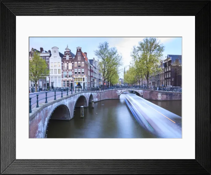 Framed Print : Long exposure of a tourist boat crossing canals Keizersgracht from Leidsegracht at dusk, Amsterdam, Netherlands, Europe Framed Print : Long exposure of a tourist boat crossing canals Keizersgracht from Leidsegracht at dusk, Amsterdam, Netherlands, Europe