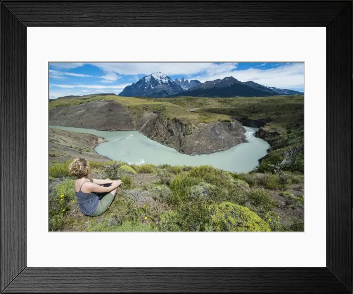 Framed Print : Woman sitting above a river bend in front of the Torres del Paine National Park, Patagonia, Chile, South America Framed Print : Woman sitting above a river bend in front of the Torres del Paine National Park, Patagonia, Chile, South America