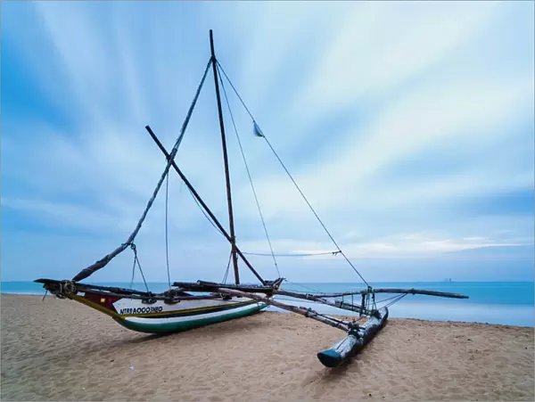Outrigger fishing boat on Negombo Beach at sunrise, Sri Lanka, Asia