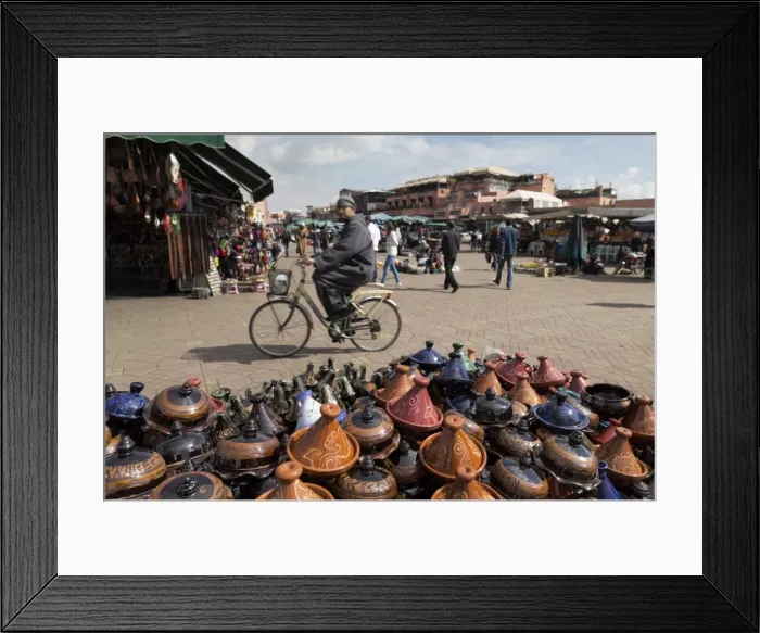 Framed Print : Cyclist passing a stall selling traditional clay tajine cooking pots in Place Jemaa el-Fna, Marrakesh, Morocco, North Africa, Africa Framed Print : Cyclist passing a stall selling traditional clay tajine cooking pots in Place Jemaa el-Fna, Marrakesh, Morocco, North Africa, Africa