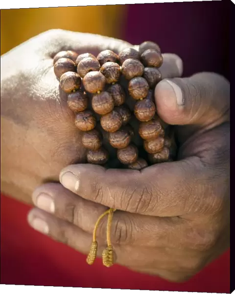 A Buddhist monk holds prayer beads (Japa Mala), Bodhnath, Nepal, Asia