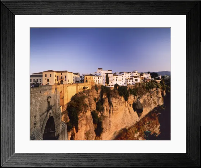 Framed Print : Houses on the Tajo edge and the bridge Puente Nuevo, old town of Ronda at sunset, Province Malaga, Andalusia, Spain, Europe Framed Print : Houses on the Tajo edge and the bridge Puente Nuevo, old town of Ronda at sunset, Province Malaga, Andalusia, Spain, Europe