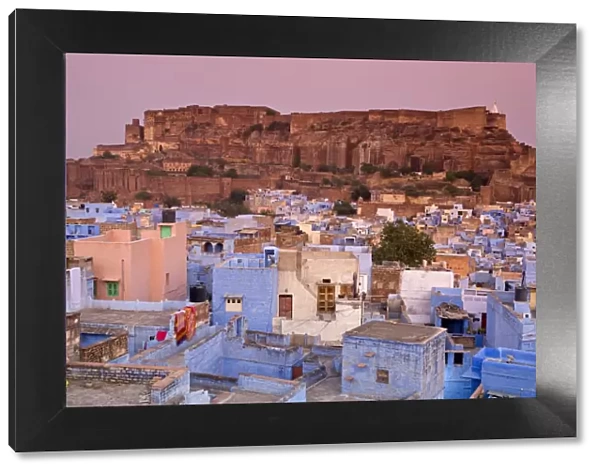 Elevated view over colorful houses of the Blue City towards Meherangarh Fort, Jodhpur, Western Rajasthan, India, Asia